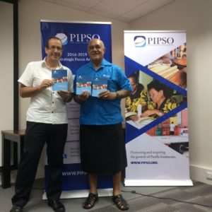 EU Ambassador Jacobs and PIPSO Chair Howard Politini holding Strategic Plan booklets.