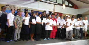 Seketi (middle in red), receives her certificate with the other chefs for the Chefs Training Programme.