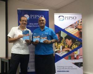 EU Ambassador Jacobs and PIPSO Chair Howard Politini holding Strategic Plan booklets.